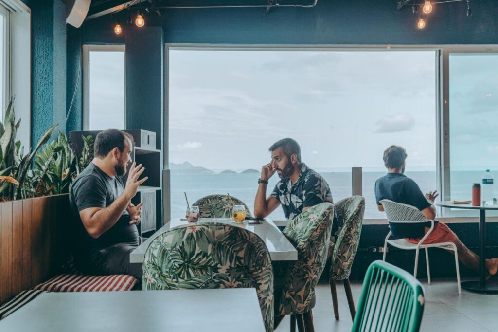 Entrepreneurs networking at The Grid Copacabana with ocean views