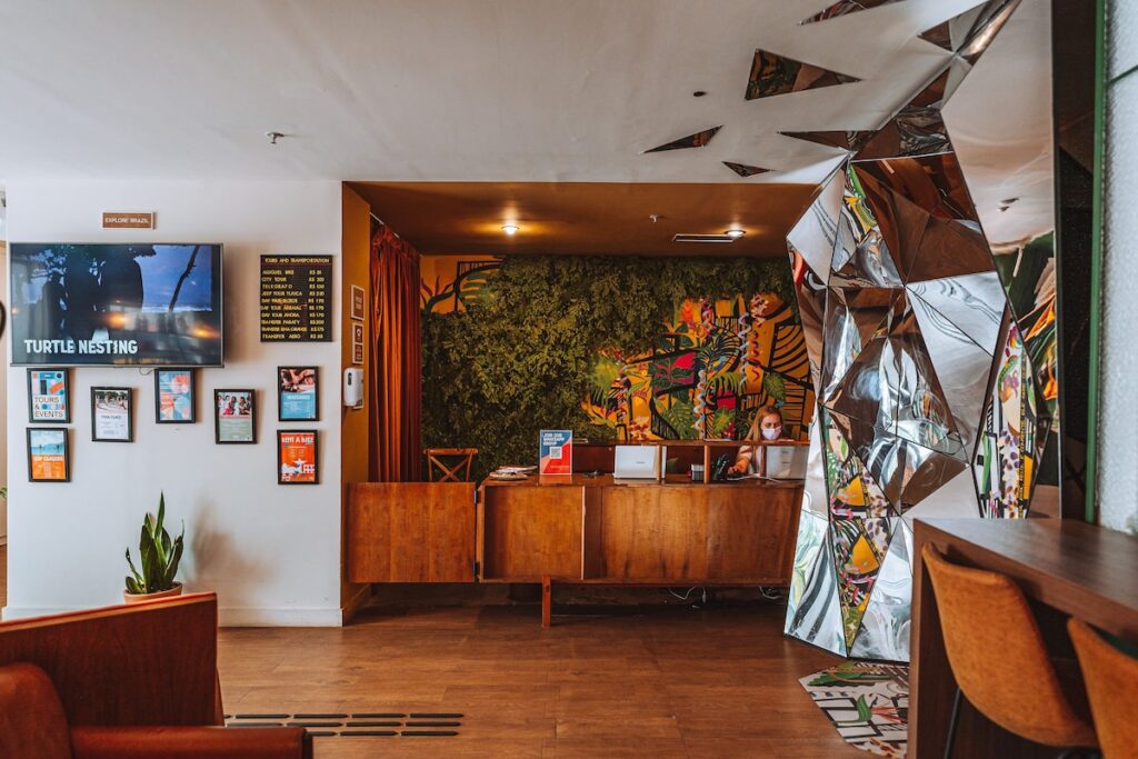 Wellness Lab reception area at The Grid Rio with tropical mural and mirrored wall